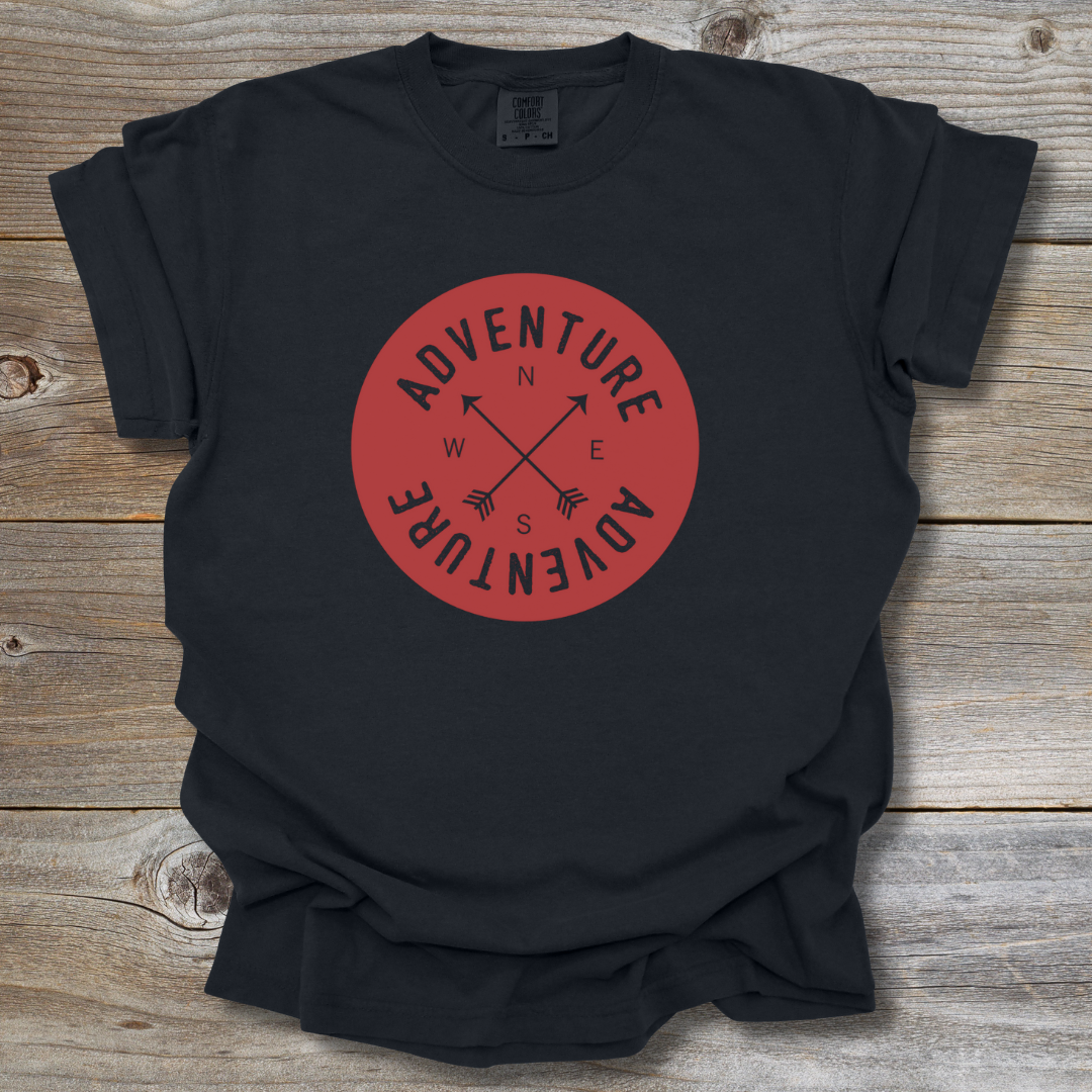 Black t-shirt with a red 'Adventure' logo on a wooden surface