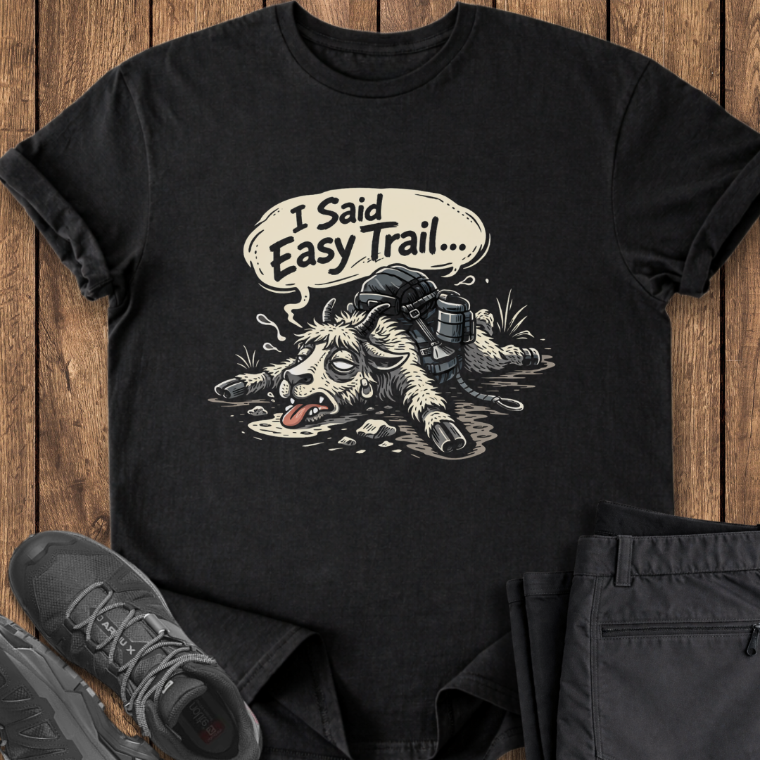 Black t-shirt with graphic design and text 'I Said Easy Trail' on a wooden surface. funny goat slow hiking t shirt