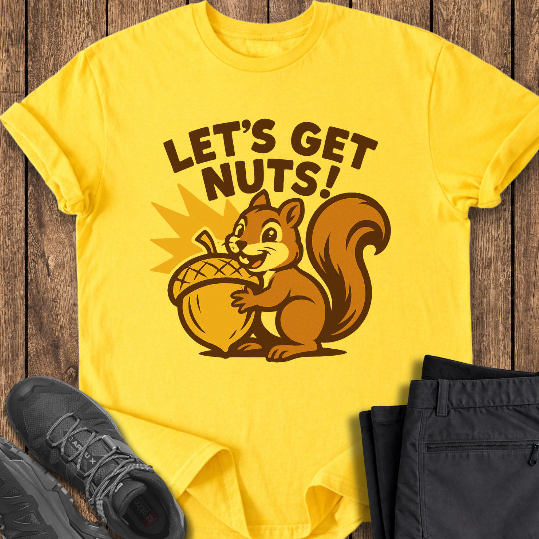 Yellow t-shirt with a squirrel graphic and 'Let's Get Nuts!' text on a wooden surface with shoes and pants.