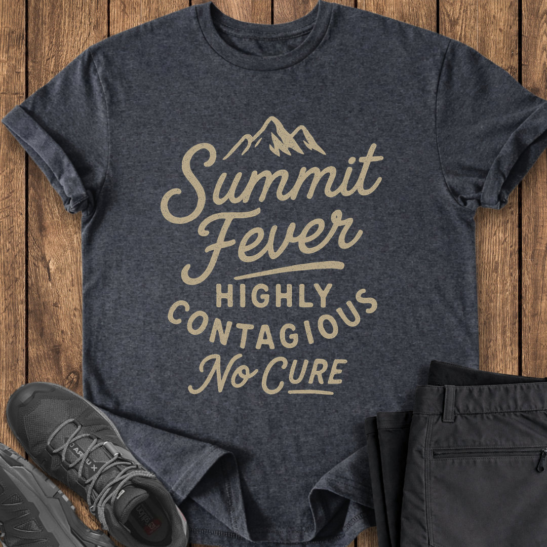 Dark gray t-shirt with 'Summit Fever Highly Contagious No Cure' text on a wooden surface, with shoes and pants for scale. mountaineering climbing