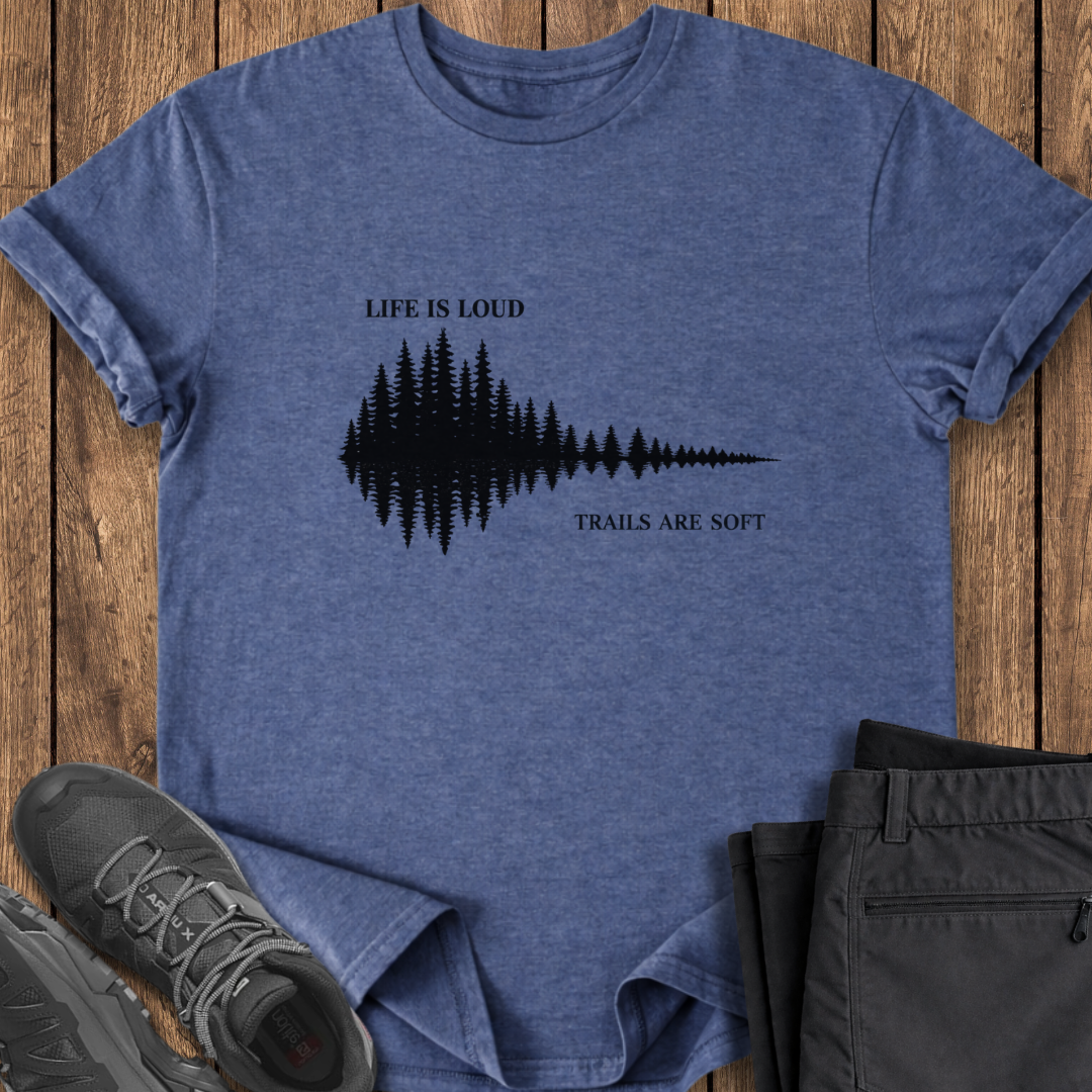 Blue t-shirt with nature-themed design on a wooden surface with shoes and pants. hiking t shirt