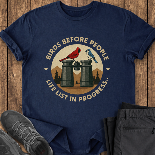 Navy blue t-shirt with bird-themed graphic on a wooden surface
