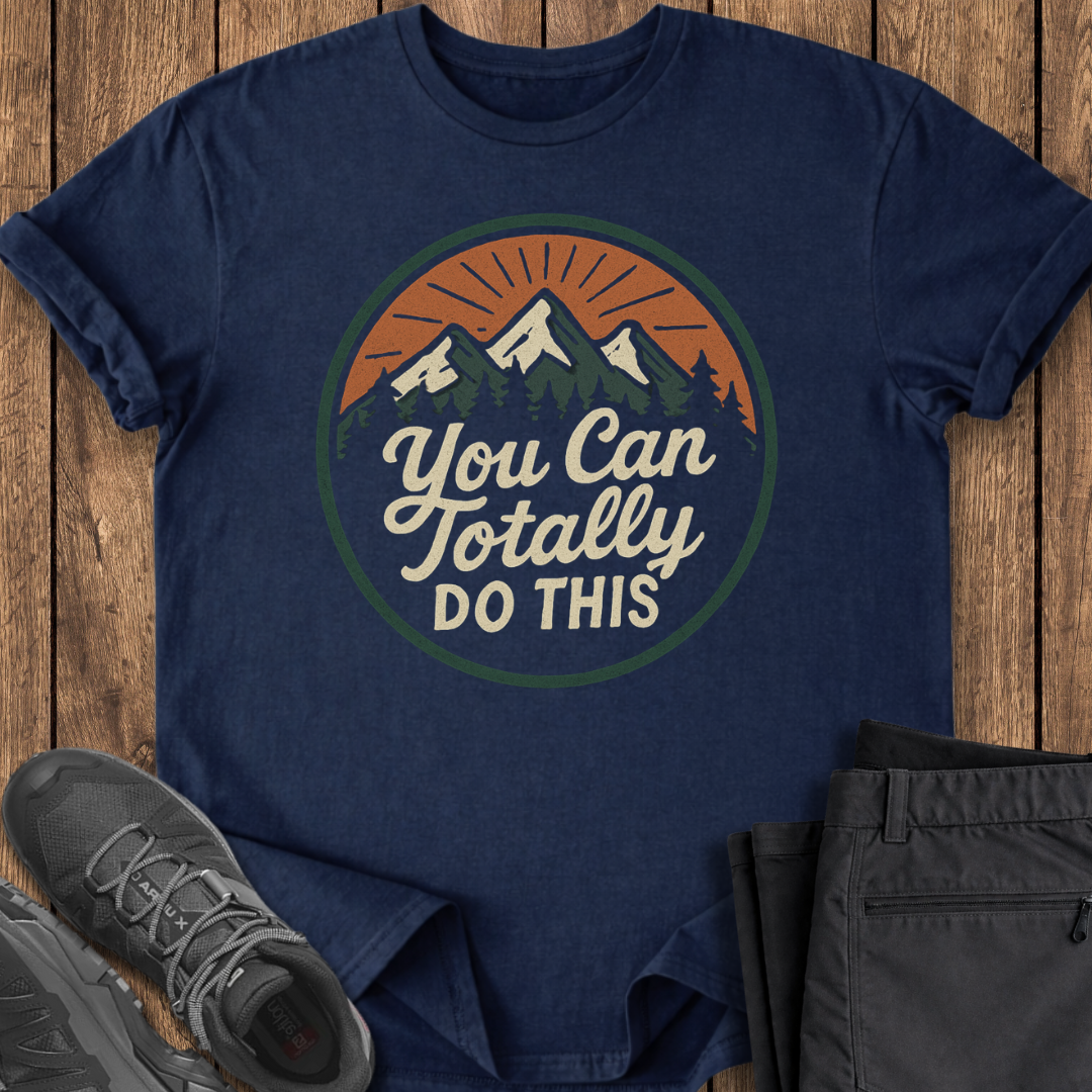 Navy blue t-shirt with motivational quote on a wooden surface with shoes and pants.