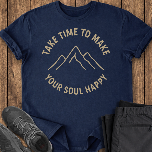 Navy blue t-shirt with motivational quote on a wooden surface with shoes and pants.
