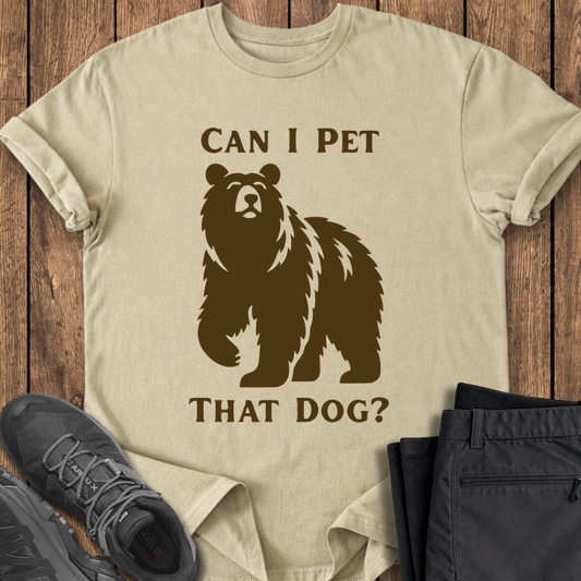 Beige t-shirt with bear graphic and text on a wooden surface with shoes and pants. viral tiktok funny hiking t shirt