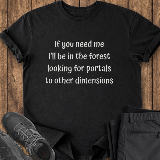 Black t-shirt with humorous text on a wooden surface with shoes and pants. funny hiking exploring t shirt