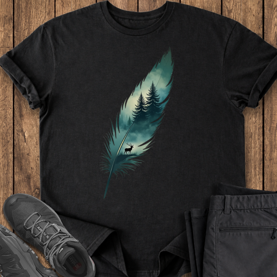 Black t-shirt with nature-themed design on a wooden surface with shoes and pants.