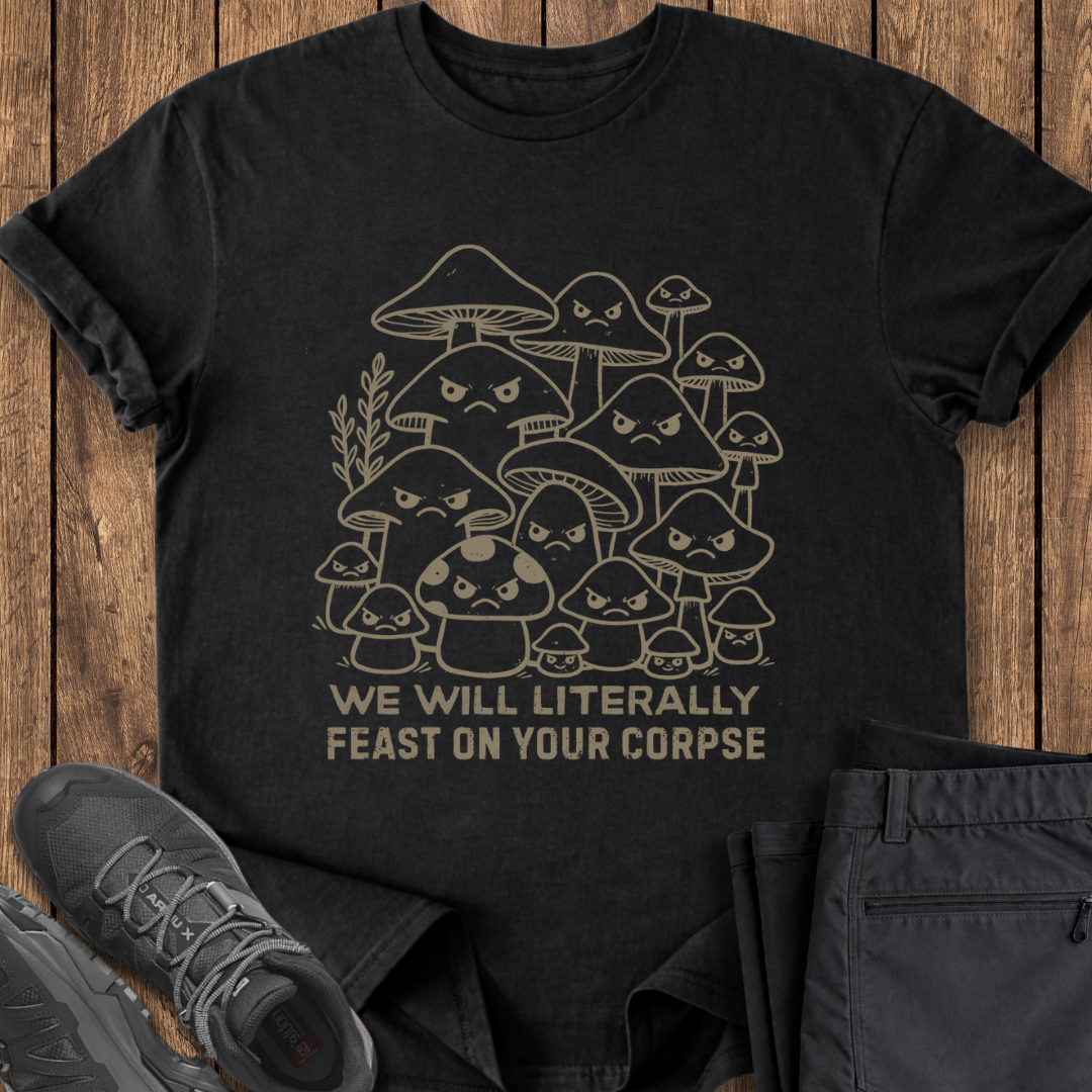 Black t-shirt with mushroom graphic and text on a wooden surface