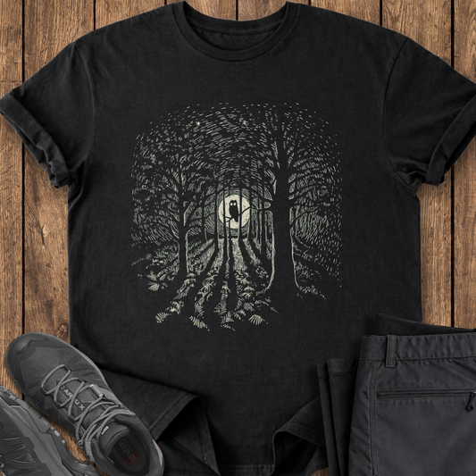 Black t-shirt with forest design on a wooden surface with shoes and pants. owl birding t shirt