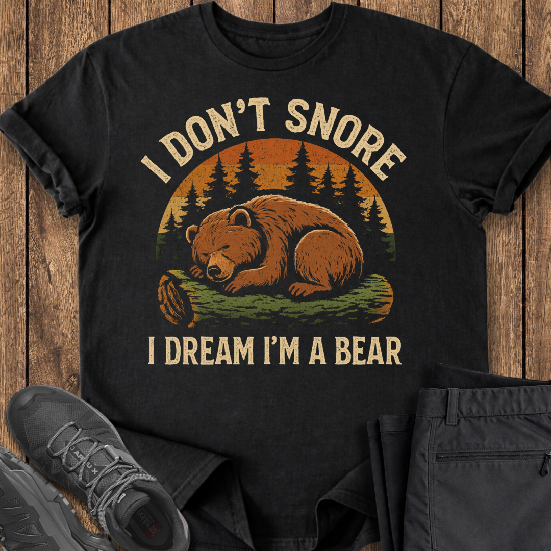 Black t-shirt with bear graphic and text on a wooden surface