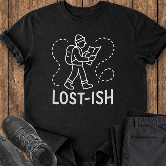 Black t-shirt with 'LOST-ISH' graphic on a wooden surface with shoes and pants.