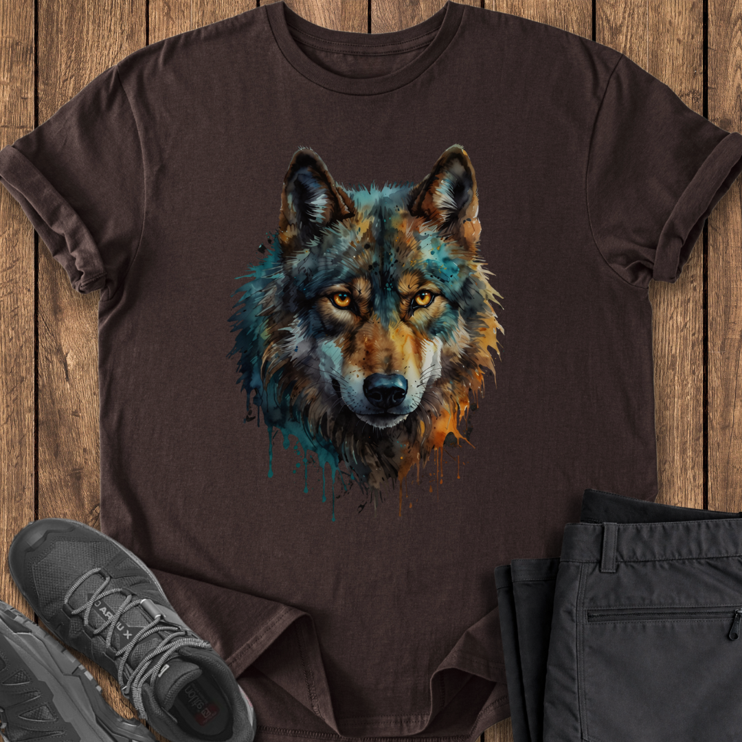 Brown t-shirt with a wolf graphic on a wooden surface with shoes and pants.