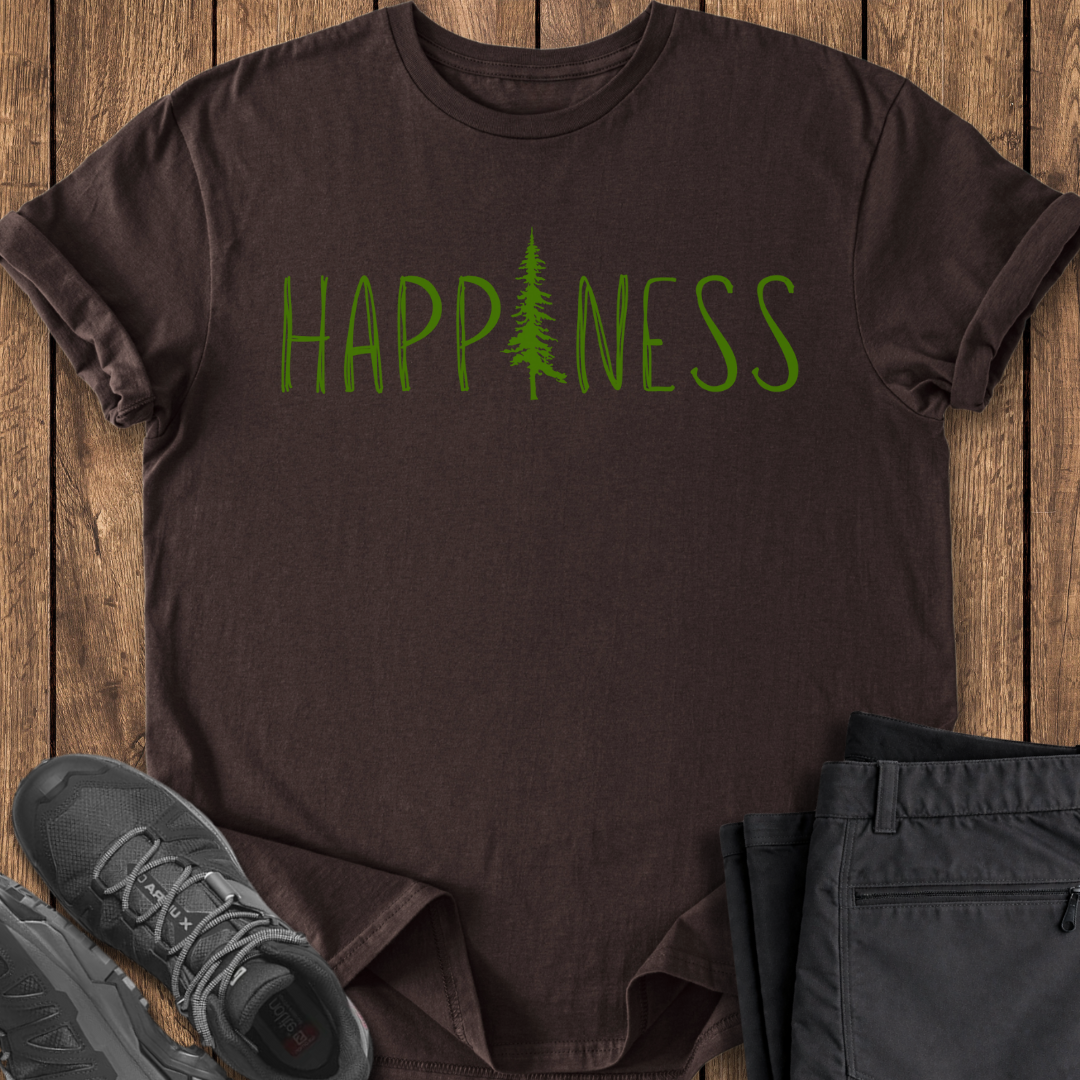 Brown t-shirt with 'HAPPINESS' printed in green on a wooden surface with shoes and pants.