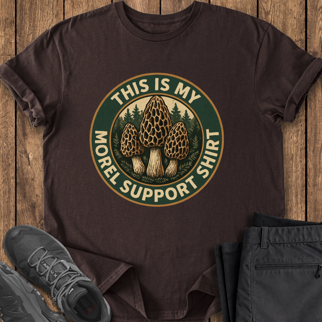 Brown t-shirt with mushroom graphic and text on a wooden surface