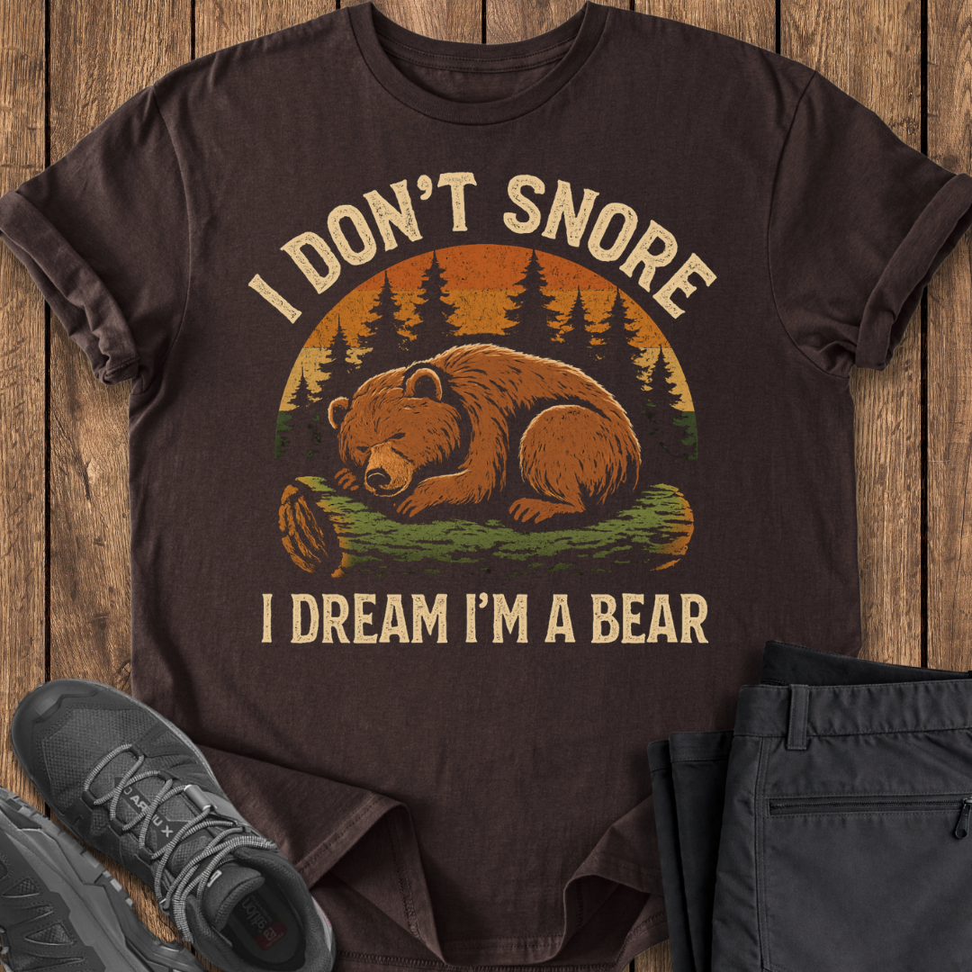 Brown t-shirt with bear graphic and text on a wooden surface