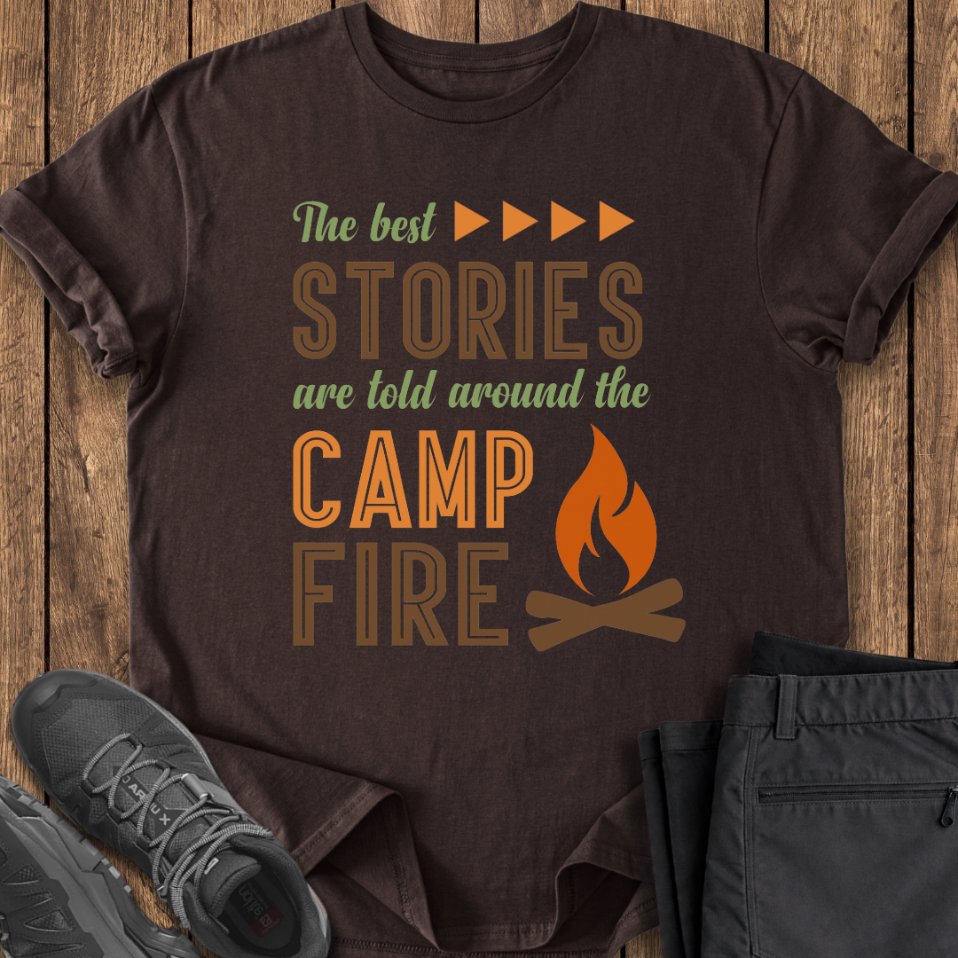 Brown t-shirt with 'The best stories are told around the campfire' text and graphics on a wooden surface. camp camper t shirts