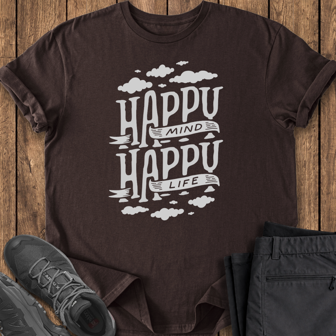 Brown t-shirt with 'Happy Mind Happy Life' text on a wooden surface with shoes and pants.