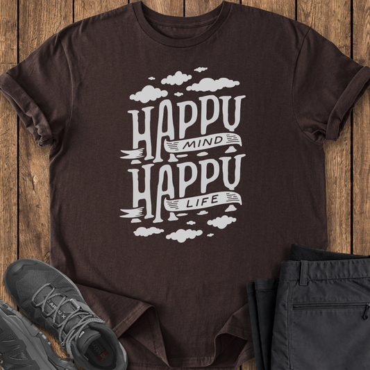 Brown t-shirt with 'Happy Mind Happy Life' text on a wooden surface with shoes and pants.
