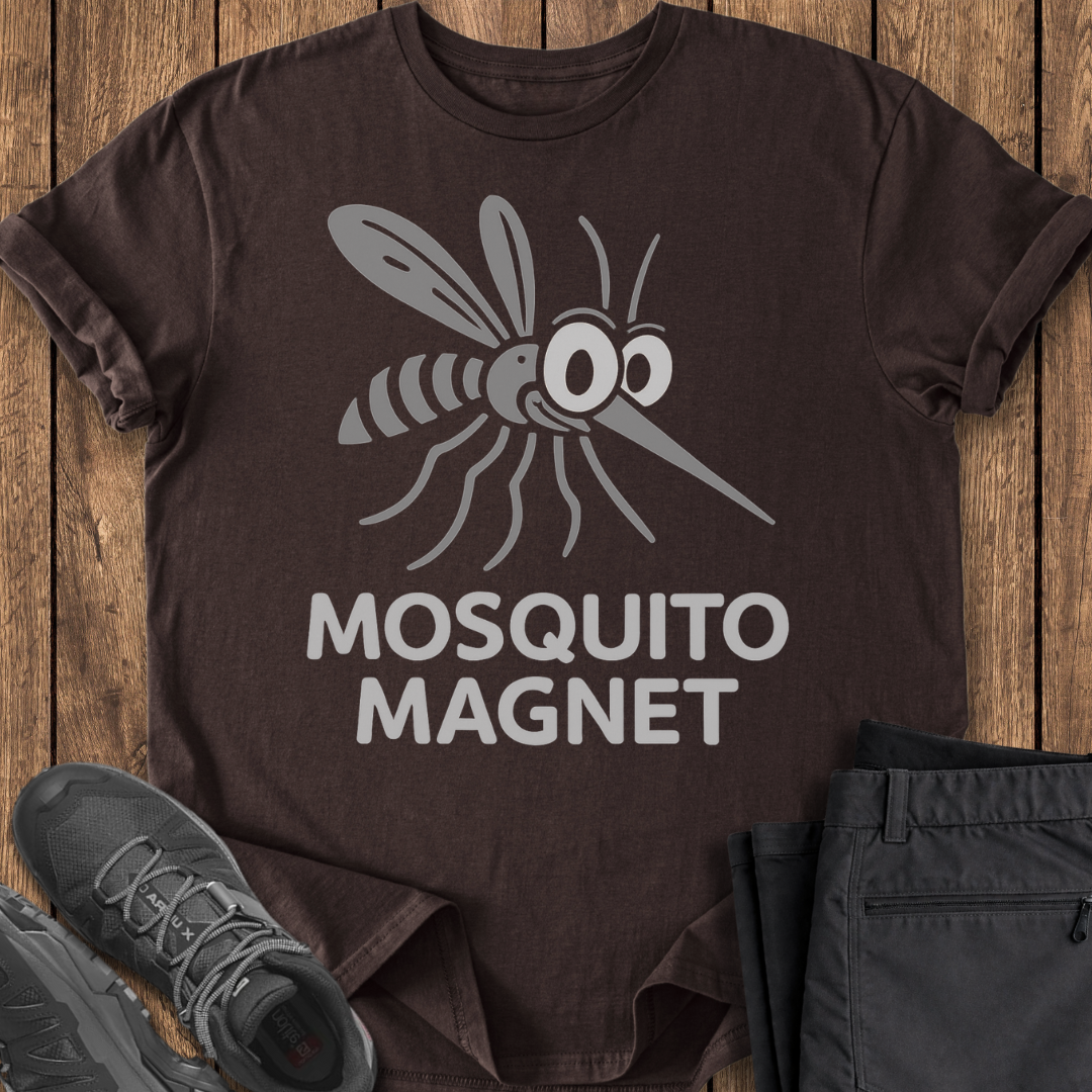 Brown t-shirt with mosquito graphic and 'Mosquito Magnet' text on a wooden surface.