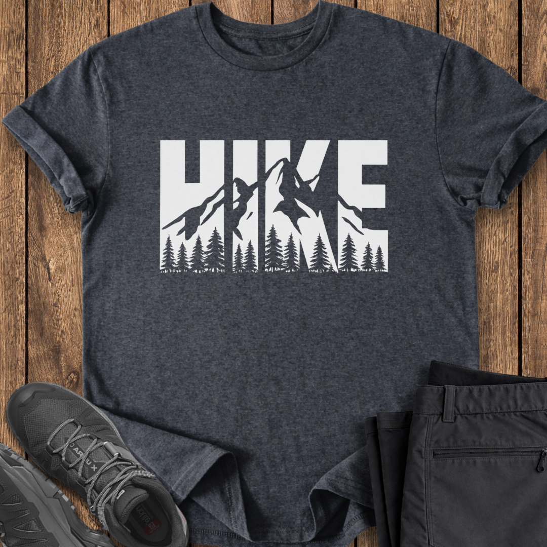 Dark gray t-shirt with 'HIKE' graphic on a wooden surface with shoes and pants.
