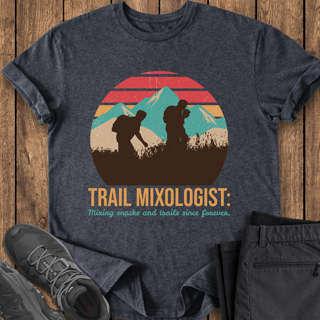 Dark gray t-shirt with 'Trail Mixologist' graphic on a wooden surface with shoes and pants. funny trail t shirt
