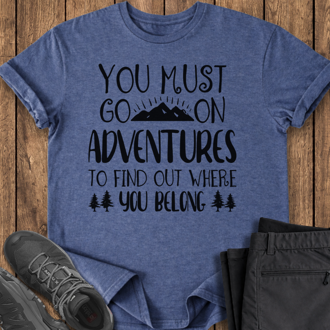 Blue t-shirt with motivational quote on a wooden surface with shoes and pants.