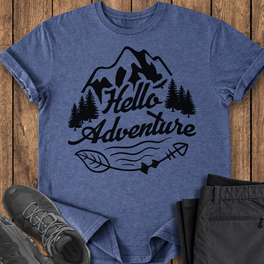 Blue t-shirt with 'Hello Adventure' design on a wooden surface with shoes and pants. adventure t shirt