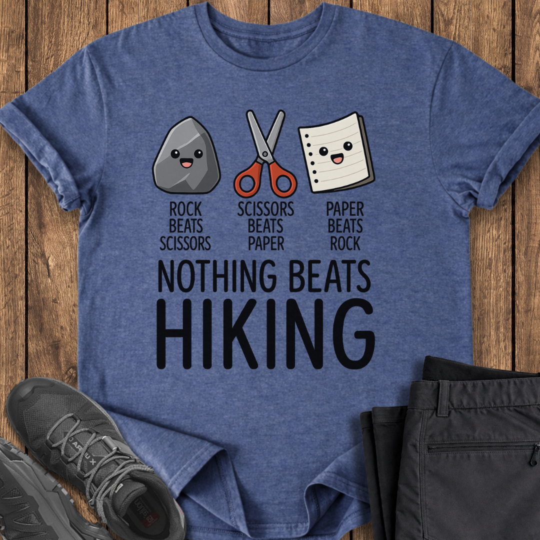 Blue t-shirt with rock, scissors, paper graphic and 'Nothing Beats Hiking' text on a wooden surface.