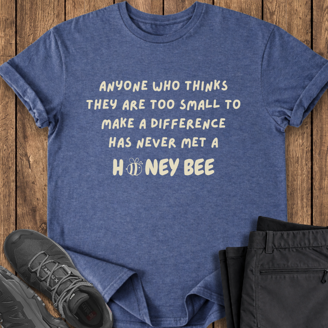 Blue t-shirt with motivational quote on a wooden surface with shoes and shorts.  environmental conservation bees