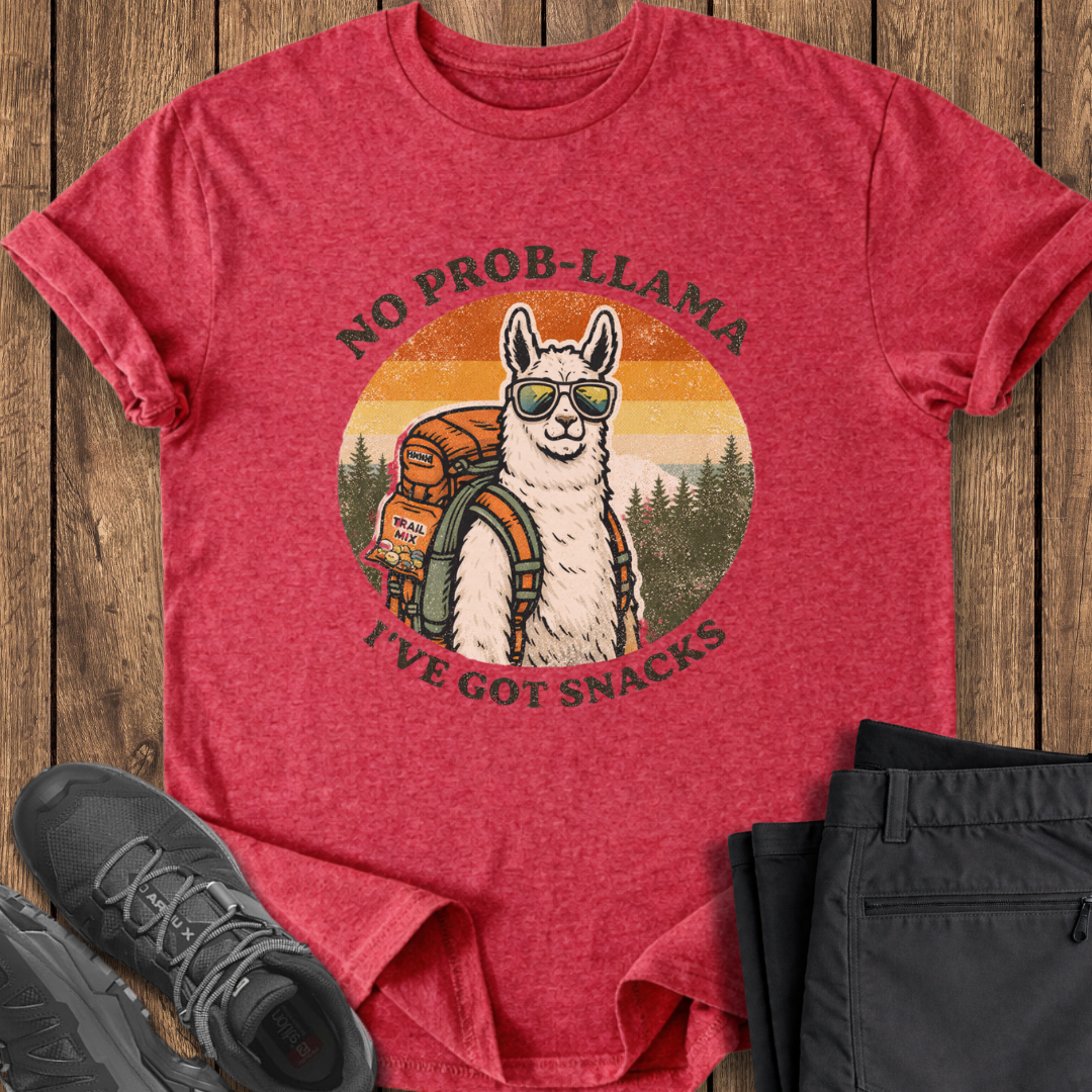 Red t-shirt with a llama graphic and text on a wooden surface, surrounded by black shoes and pants. funny hiking t shirts