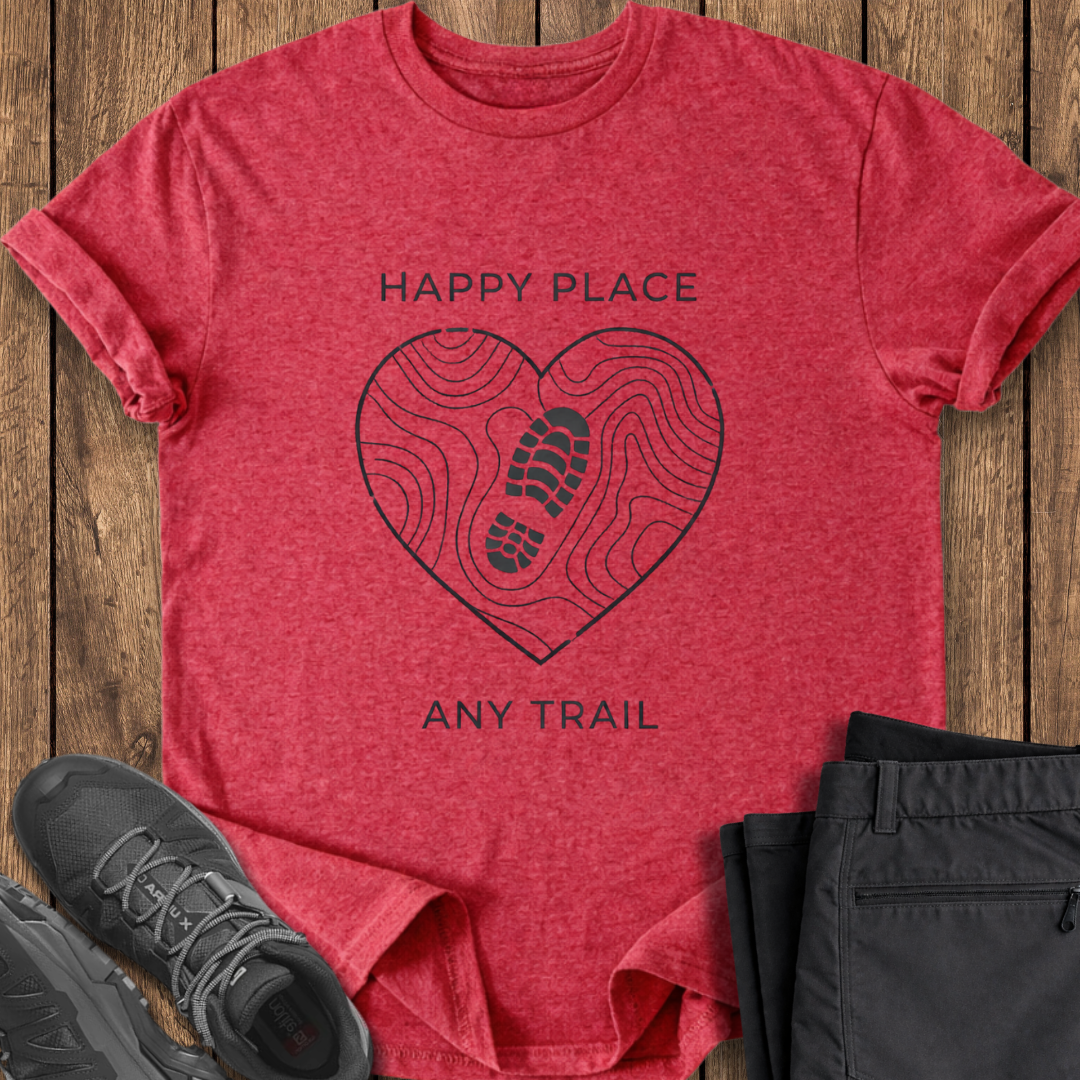Red t-shirt with heart-shaped footprint design and text on a wooden surface with black pants and shoes. my happy place mindful tshirt