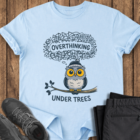 Light blue t-shirt with an owl graphic and text on a wooden surface anxiety hiking t shirts
