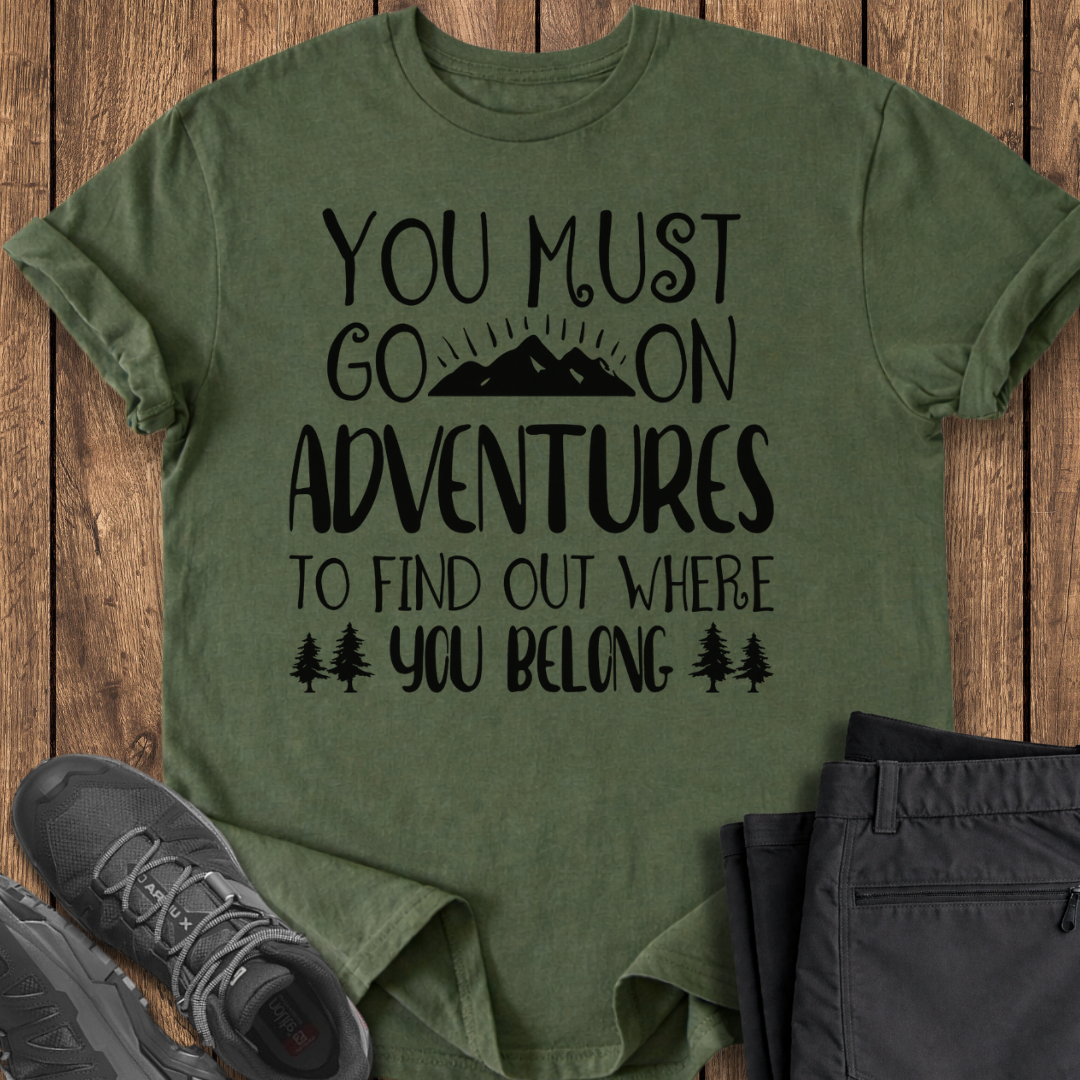 Green t-shirt with motivational quote on a wooden surface with shoes and pants.