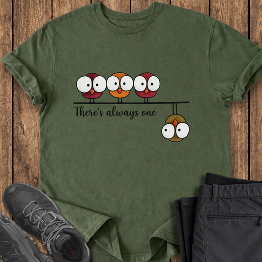 Green t-shirt with cartoon owls design on a wooden surface with shoes and pants. funny birding hiking camping t shirt