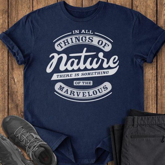 Navy blue t-shirt with motivational quote on a wooden surface with shoes and pants.