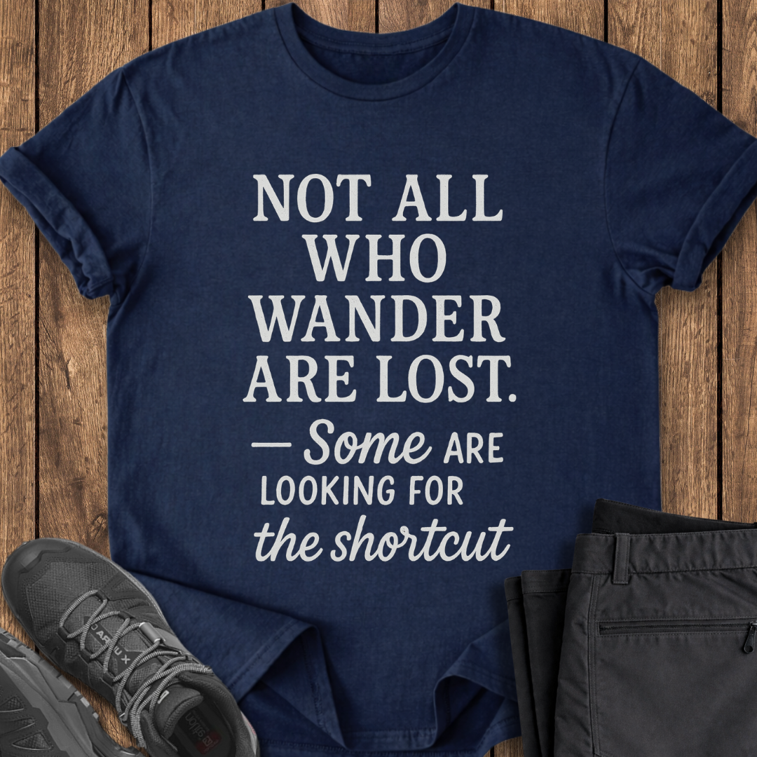 Navy blue t-shirt with motivational quote on a wooden surface with shoes and pants. funny hiking t shirt