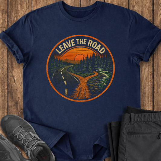 Navy blue t-shirt with 'Leave the Road' graphic on a wooden surface with shoes and pants.