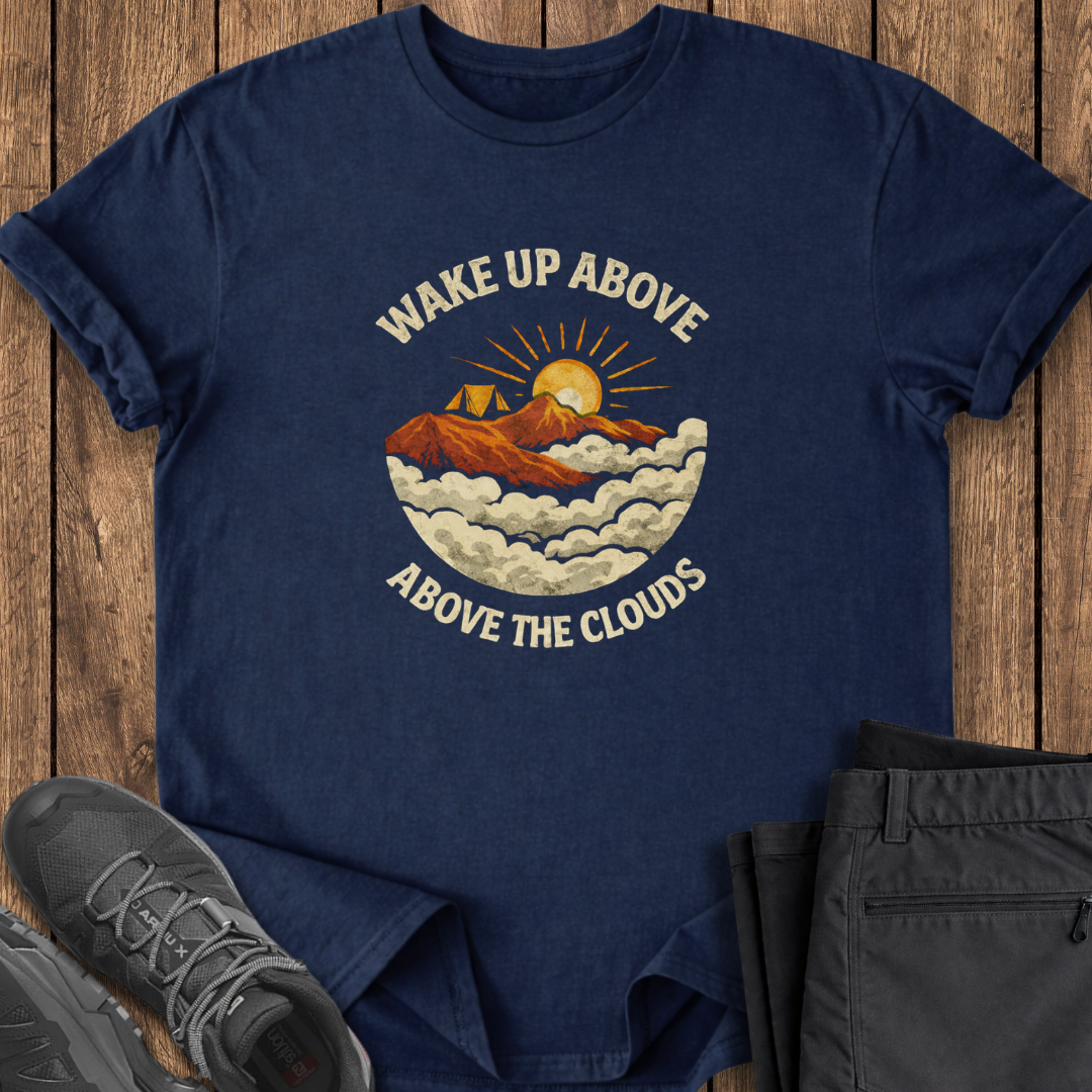 Navy blue t-shirt with mountain graphic and text on a wooden surface, with shoes and pants for scale. mountain camping  shirt