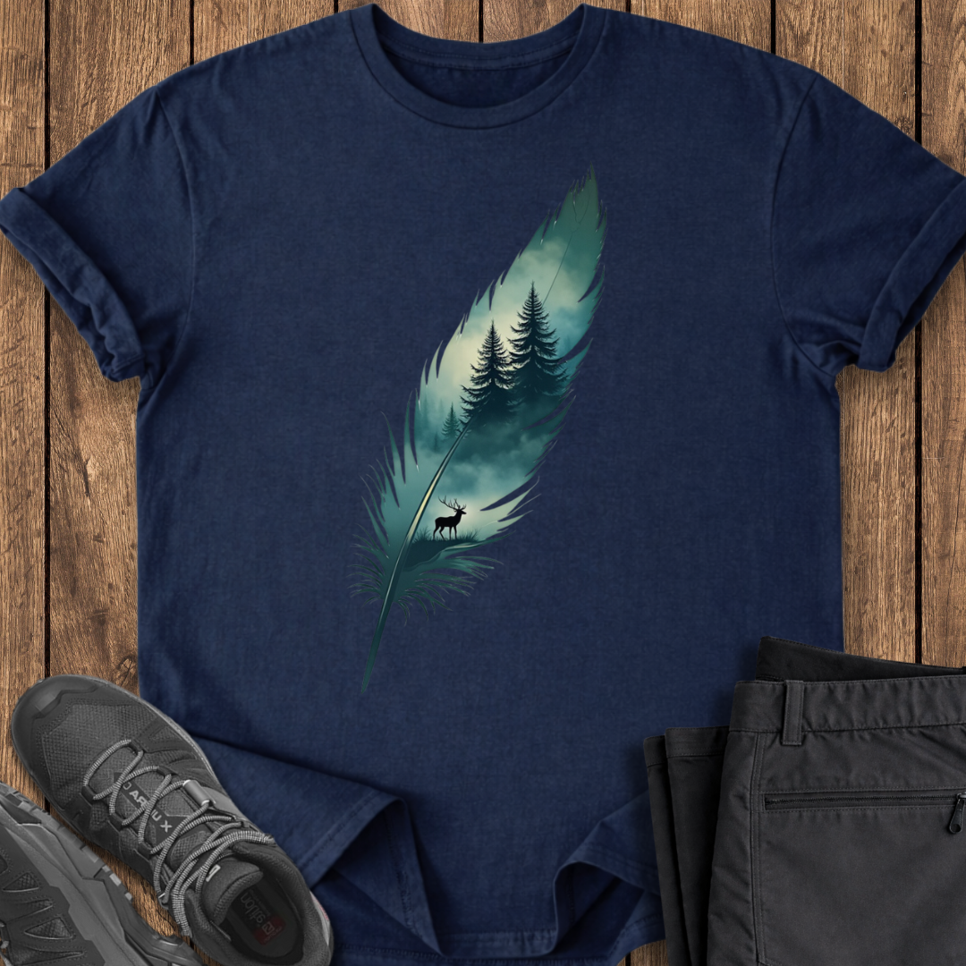 Navy blue t-shirt with a feather design featuring trees and a deer on a wooden surface, with shoes and pants partially visible.