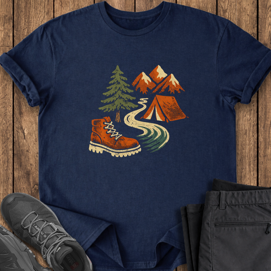 Navy blue t-shirt with outdoor design featuring a boot, tent, and mountains on a wooden surface.