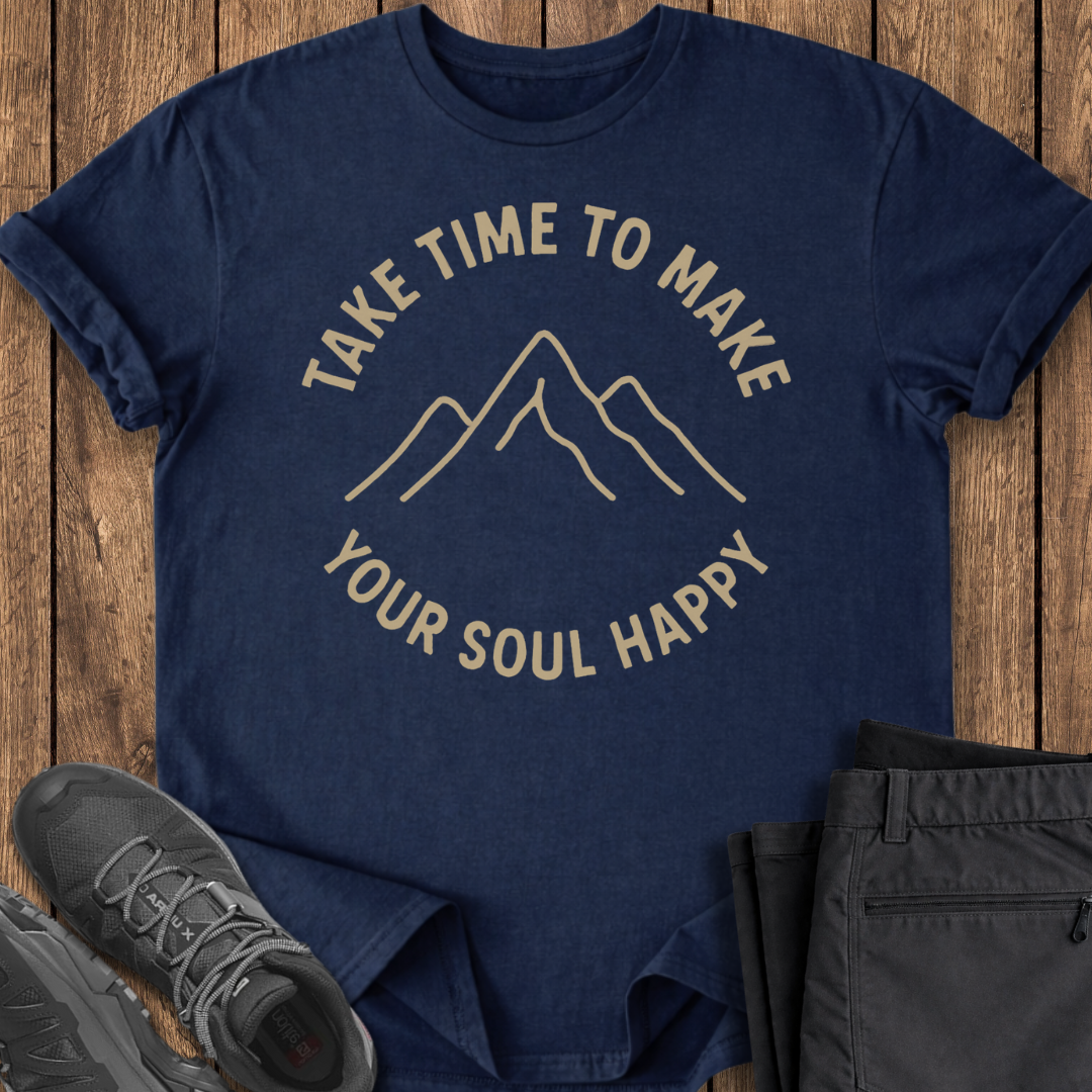 Navy blue t-shirt with motivational quote on a wooden surface with shoes and pants.