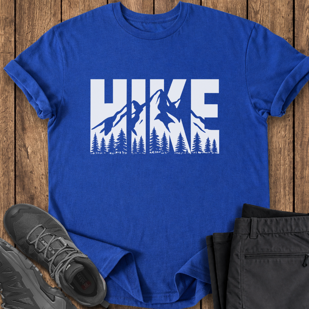 Blue t-shirt with 'HIKE' graphic on a wooden surface with black pants and shoes.