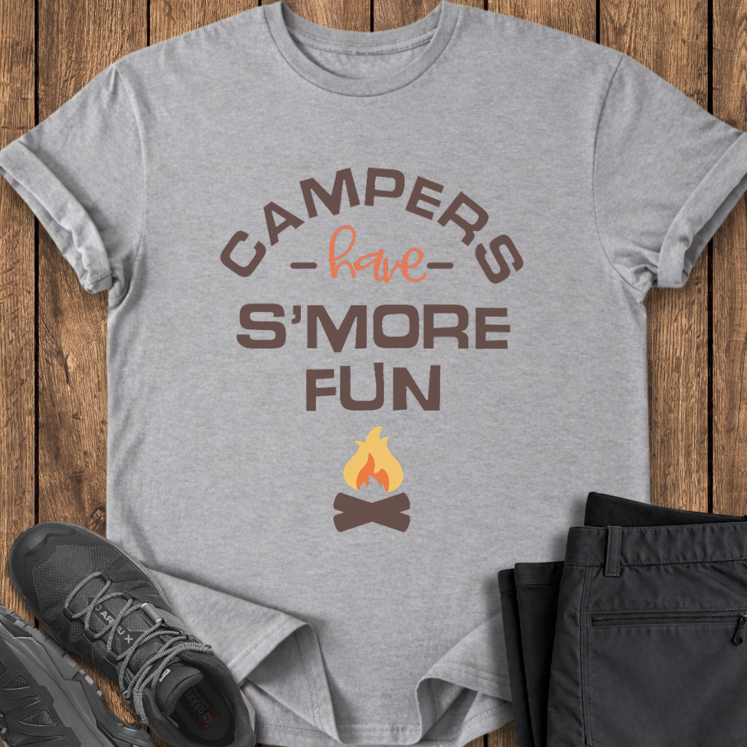 Gray t-shirt with 'Campers have S'more Fun' text and campfire graphic on a wooden surface with shoes and pants. campfire funny t shirt