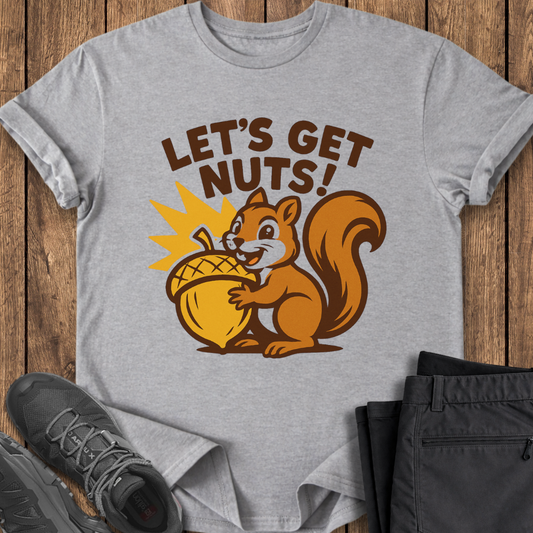 Gray t-shirt with a squirrel graphic and 'Let's Get Nuts!' text on a wooden surface with shoes and pants.