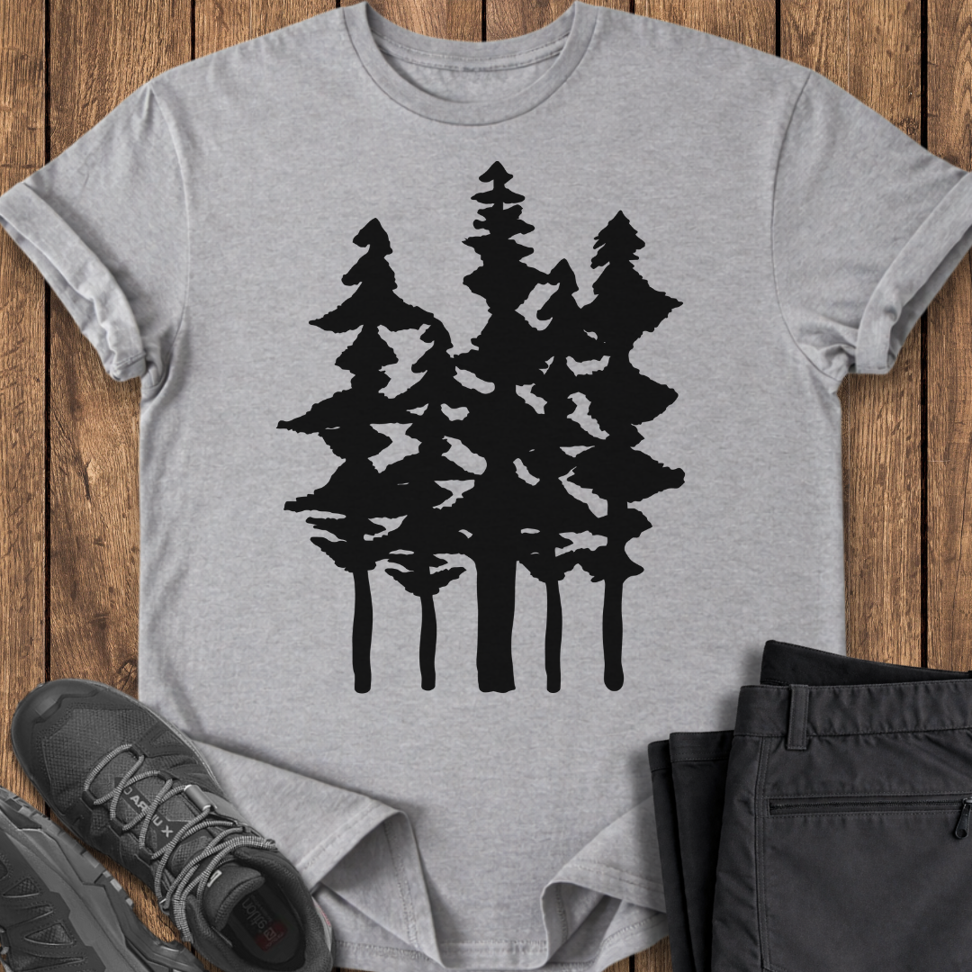Gray t-shirt with black tree design on a wooden surface with shoes and pants.