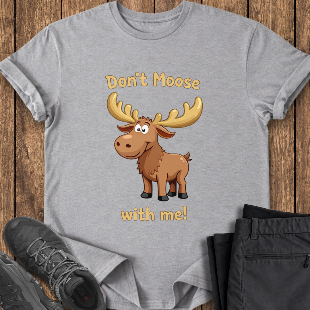 Gray t-shirt with a cartoon moose and text on a wooden surface with shoes and pants. cute funny moose t shirt