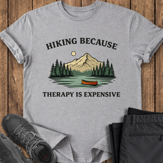 Gray t-shirt with a nature graphic and text on a wooden surface with shoes and pants. mental health funny outdoor shirt