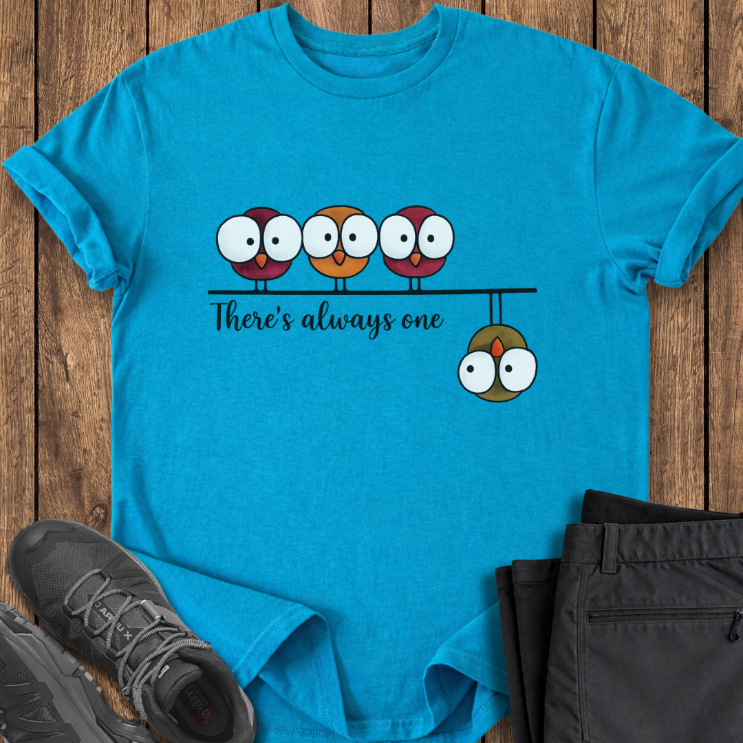 Blue t-shirt with cartoon design on a wooden surface with shoes and pants. funny birding camping hiking t shirt