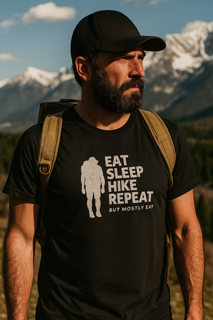 hiker wearing a black t-shirt with 'Eat Sleep Hike Repeat' text and mountains in the background